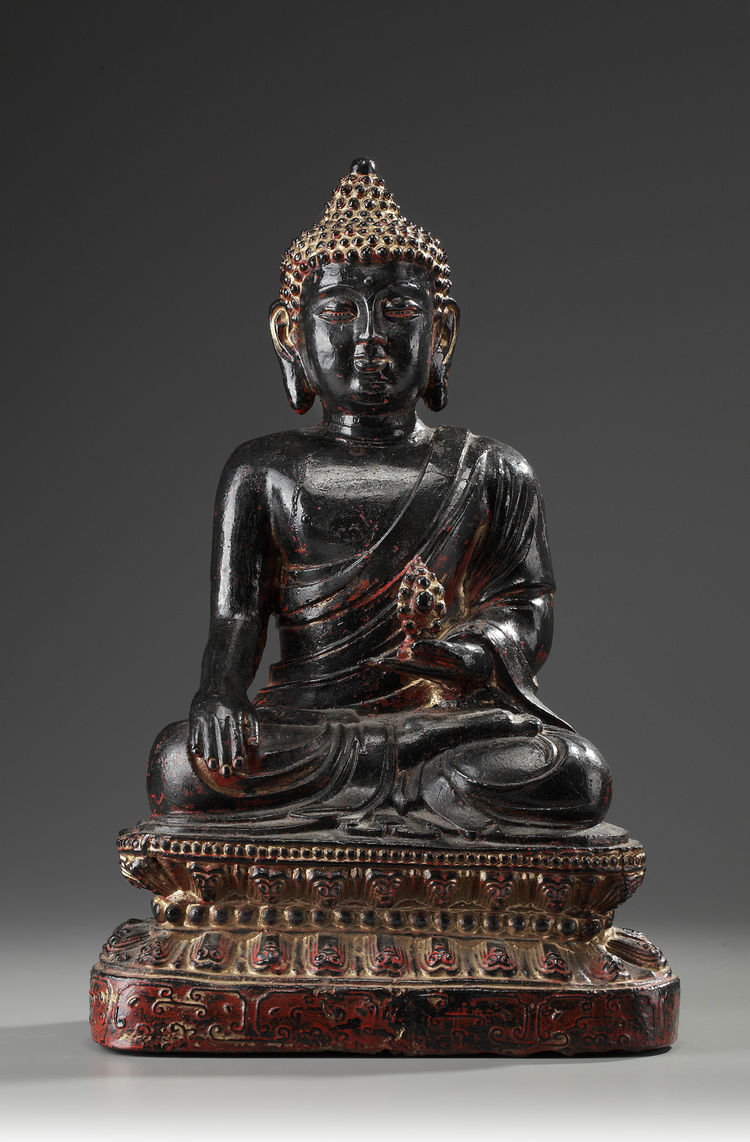 A Large Bronze Buddha Sitting on a Lotus