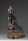 A Large Bronze Buddha Sitting on a Lotus
