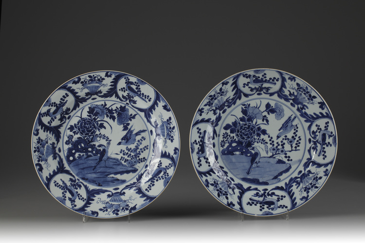 A pair of large blue and white plates