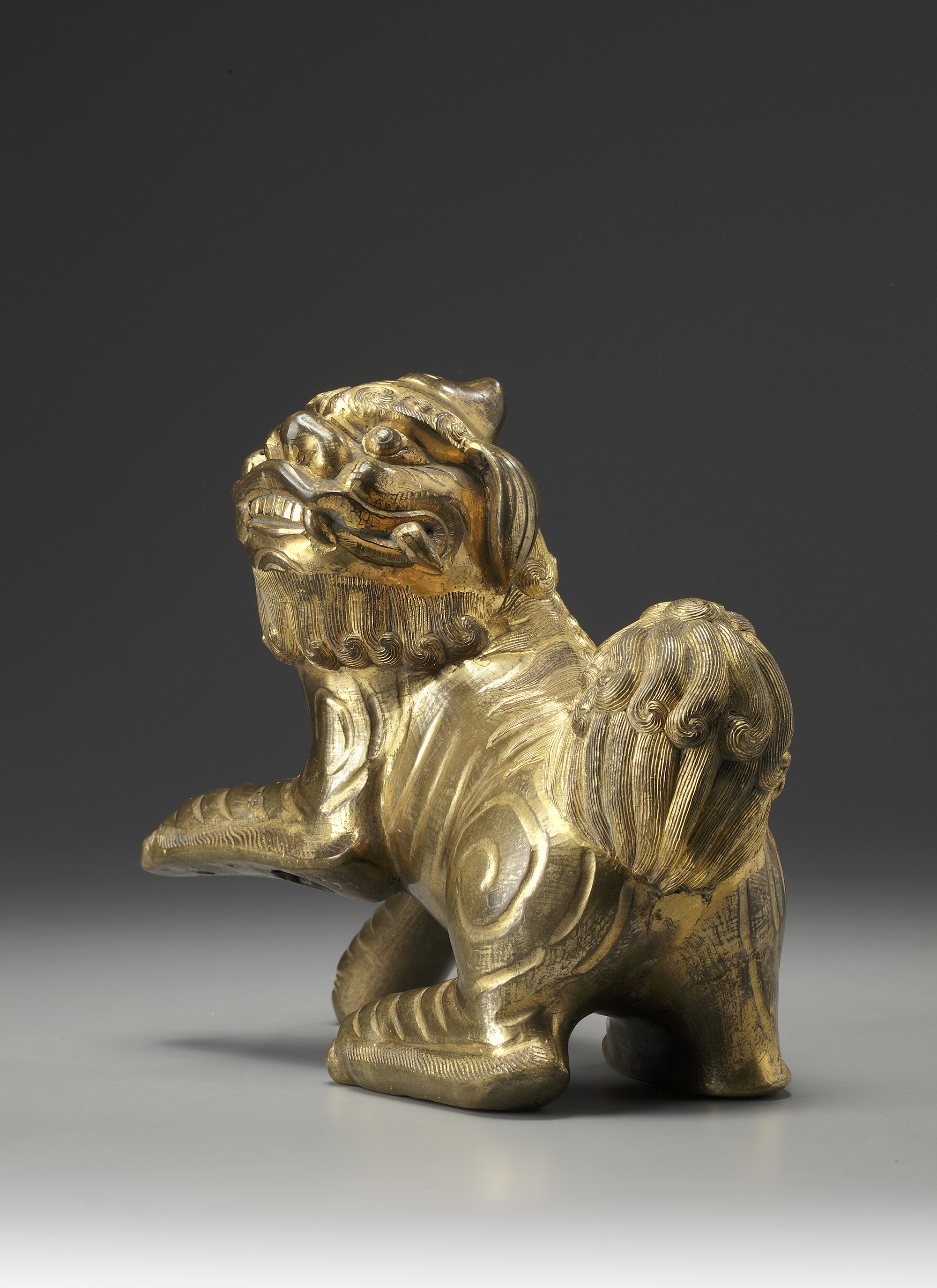 A gilt bronze Buddhist lion