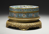 A cloisonne circular box with cover on a gilt bronze base