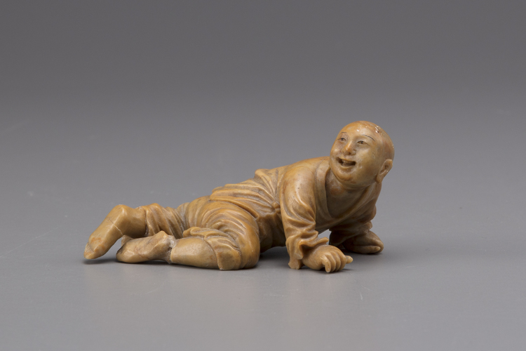 A soapstone figure of a young boy