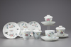 Eleven famille rose cups and saucers
