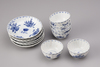 Six blue and white cups and saucers