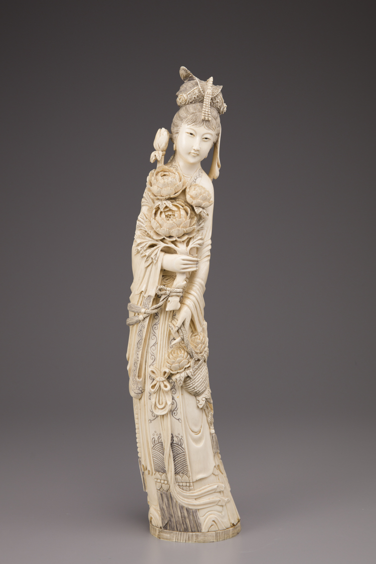 An ivory figure of a standing lady