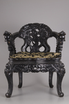 A pair of Chinese hardwood dragon chairs