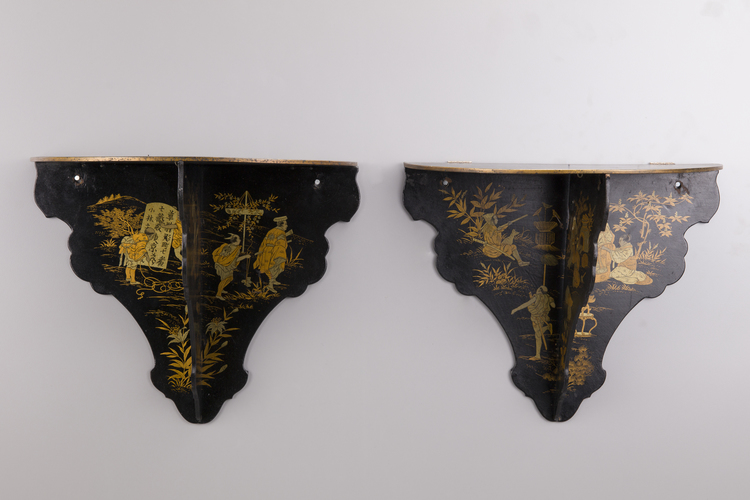 A pair of black lacquer folding wall shelves