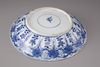 A blue and white porcelain plate with floral decorations