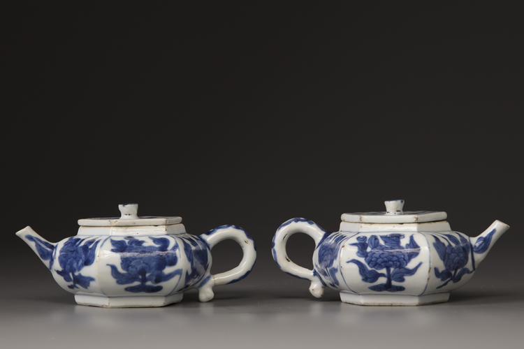 A pair of blue and white hexagonal teapots