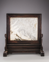 A marble 'dreamstone'-inset wood screen
