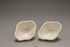 A pair of white-glazed lobed cups