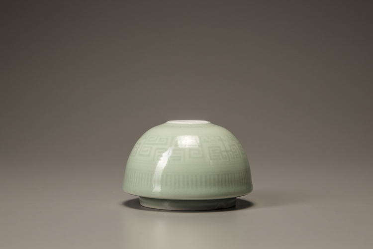 A small celadon-glazed water pot