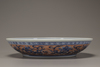 An iron-red decorated blue and white 'dragon' dish