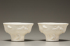 A pair of white-glazed libation cups