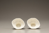 A pair of white-glazed libation cups