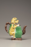 A moulded yellow, green, and aubergine-glazed teapot