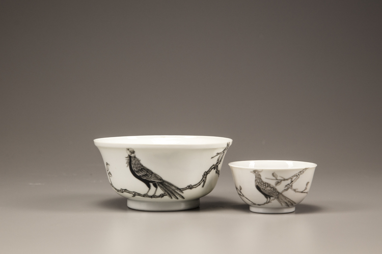 An en grisaille 'pheasant' tea cup and bowl