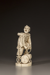 A JAPANESE IVORY OKIMONO OF A MAN REPAIRING HIS SANDAL,MEIJI PERIOD (1868-1912)