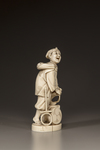 A JAPANESE IVORY OKIMONO OF A MAN REPAIRING HIS SANDAL,MEIJI PERIOD (1868-1912)