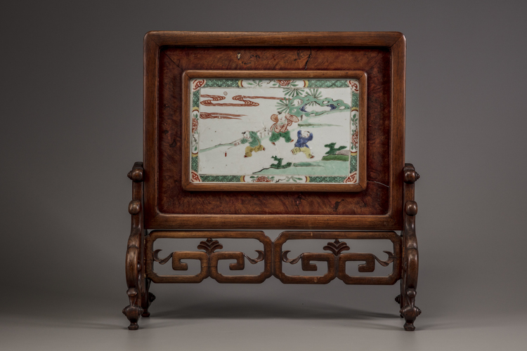 A famille verte 'boys' plaque mounted as a table screen