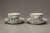 Two pairs of famille rose 'Eight Horses of Mu Wang' foliate cups and saucers