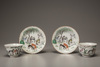 Two pairs of famille rose 'Eight Horses of Mu Wang' foliate cups and saucers