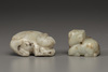 A creamy jade water buffalo and a celadon and russet jade Buddhist lion