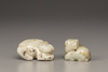 A creamy jade water buffalo and a celadon and russet jade Buddhist lion