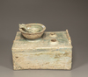 A green-glazed pottery cooking stove, bowl, and ladle