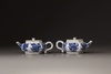 A pair of blue and white hexagonal teapots