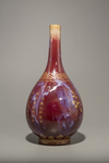 A flambé glazed gilt-inscribed bottle vase