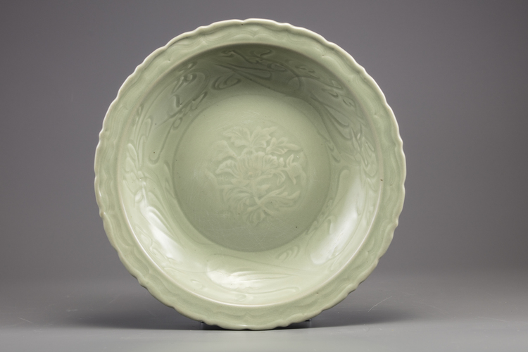 A large Chinese celadon-glazed dish