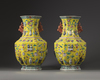 A pair of Chinese yellow-ground appliqué-decorated octagonal vases