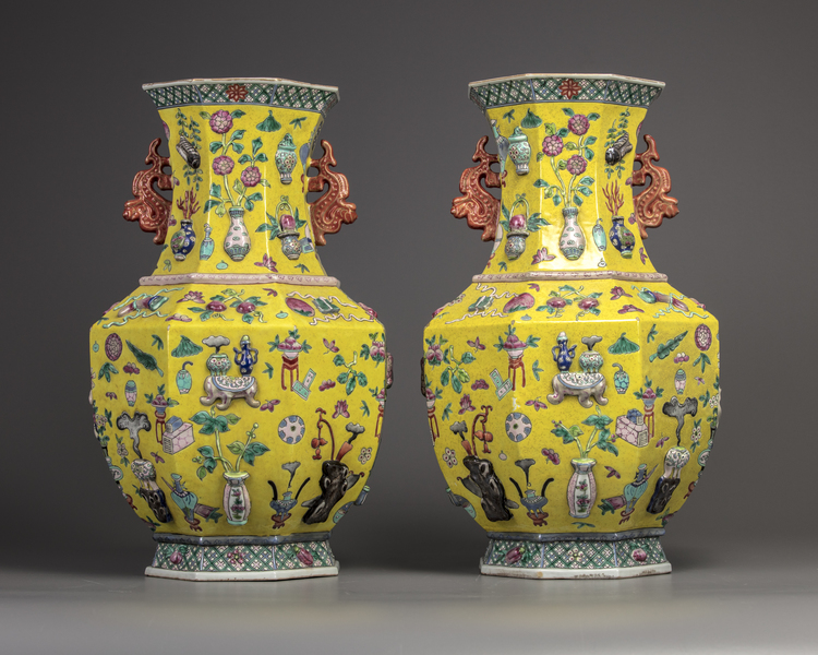 A pair of Chinese yellow-ground appliqué-decorated octagonal vases