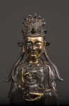 A Chinese parcel-gilt bronze figure of Xiwangmu