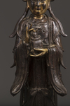 A Chinese parcel-gilt bronze figure of Xiwangmu