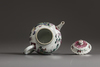 A small Chinese famille rose moulded teapot and cover