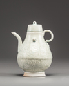 A Chinese celadon-glazed carved ewer and cover
