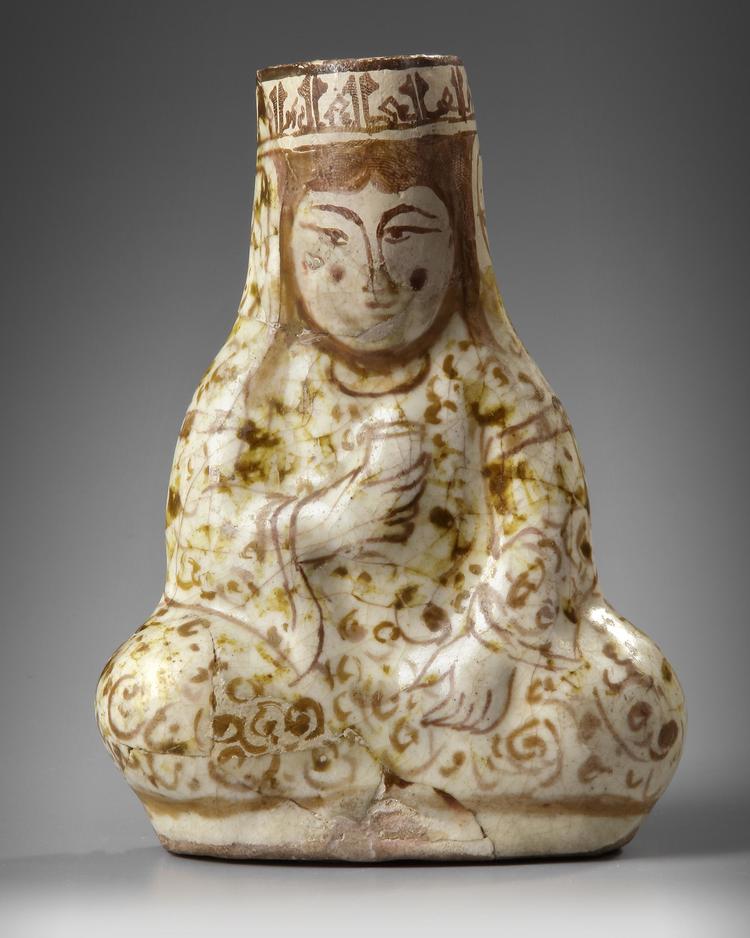 A KASHAN LUSTRE POTTERY VESSEL IN THE FORM OF A SEATED FEMALE RULER, PERSIA, 12TH-13TH CENTURY