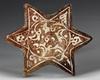 A SMALL STAR-SHAPED KASHAN TILE, PERSIA, 13TH-14TH CENTURY