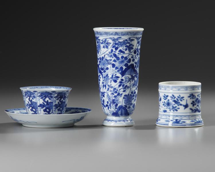 A GROUP OF THREE CHINESE BLUE AND WHITE STEMMED BEAKER AND CUP AND SAUCER AND SAMLL JAR, KANGXI (1662-1722)