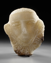 A CARVED ALABASTER FUNERARY PORTRAIT WITH INSCRIPTION TO THE NECK, LATE 1ST MILLENNIUM BC