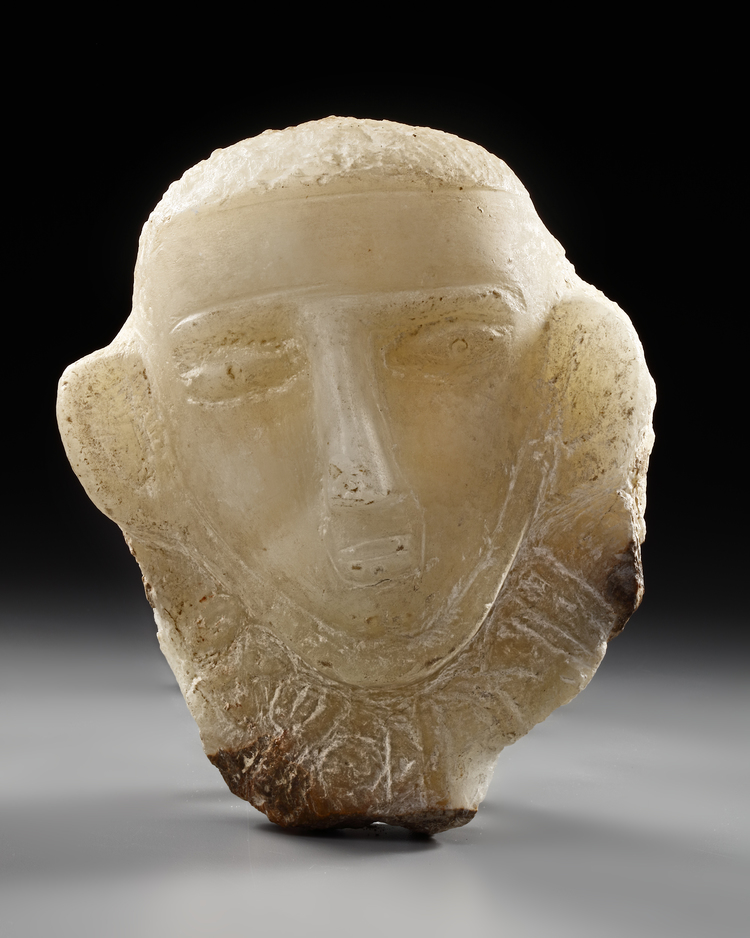 A CARVED ALABASTER FUNERARY PORTRAIT WITH INSCRIPTION TO THE NECK, LATE 1ST MILLENNIUM BC