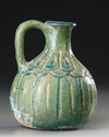 A TURQUOISE BLUE GLAZED POTTERY JUG, PERSIA, 10TH-11TH CENTURY