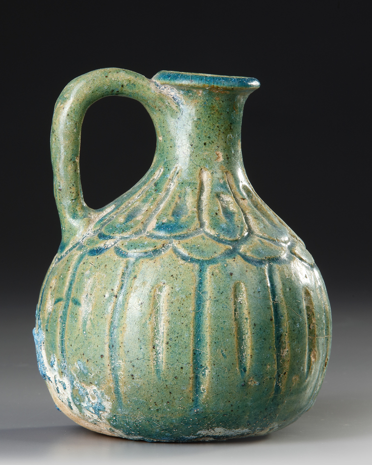A TURQUOISE BLUE GLAZED POTTERY JUG, PERSIA, 10TH-11TH CENTURY