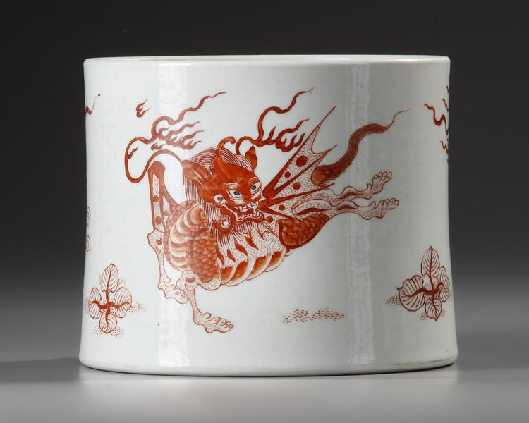 A CHINESE IRON-RED 'MYTHICAL BEAST' BRUSH POT, BITONG, QING DYNASTY