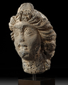 A ROMAN BASALT HEAD OF A WOMAN "HAURAN", CIRCA 2ND CENTURY A.D.