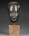 AN EGYPTIAN DIORITE HEAD OF AN OFFICIAL, LATE PERIOD, 30TH DYNASTY, 380-343 B.C.