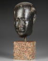 AN EGYPTIAN DIORITE HEAD OF AN OFFICIAL, LATE PERIOD, 30TH DYNASTY, 380-343 B.C.