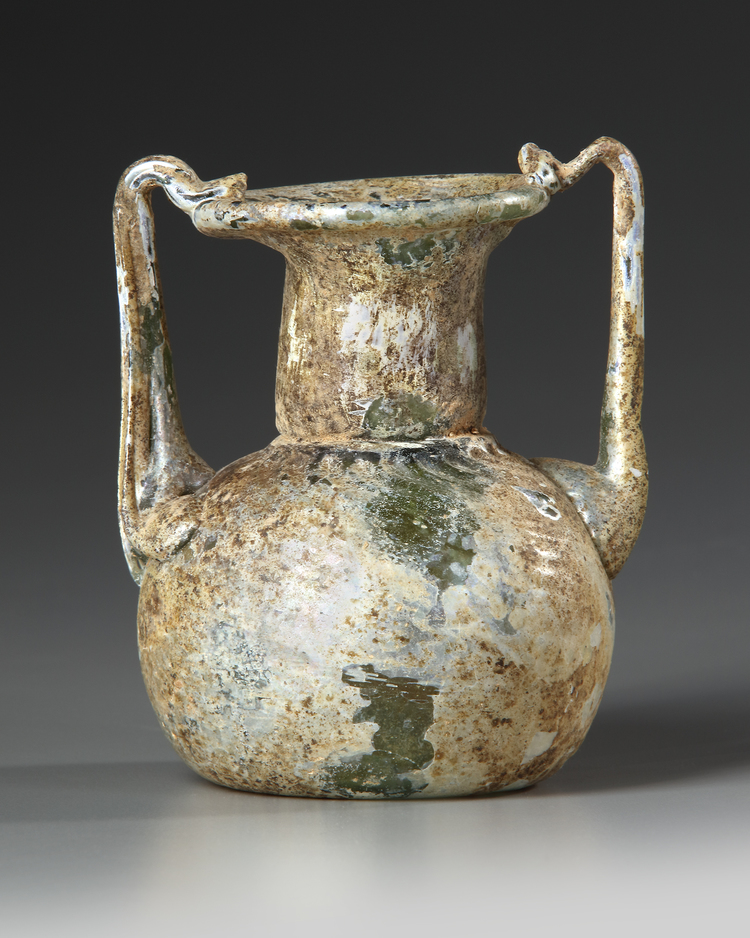 A ROMAN GLASS JAR WITH TWO HANDLES, CIRCA 3RD-4TH CENTURY A.D.
